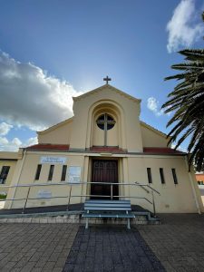 St Patrick's Catholic Church in Bunbury under a blue sky with clouds.