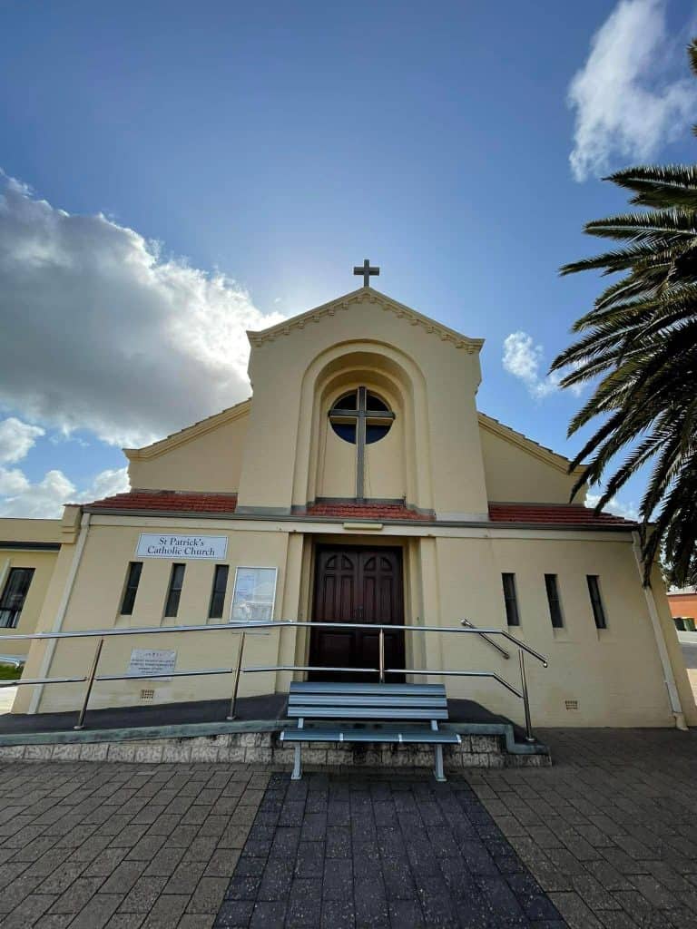 St Patrick's Catholic Church in Bunbury under a blue sky with clouds.