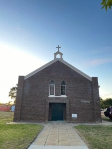 Bunbury Catholic Diocese church building with brick facade and cross on top.