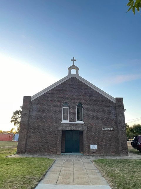 Bunbury Catholic Diocese church building with brick facade and cross on top.
