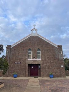 Bunbury Catholic Church building with brick facade and cross on top.
