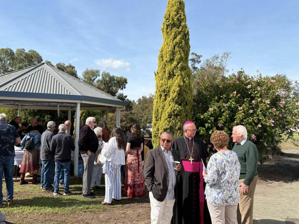 Community gathering at Bunbury Catholic Diocese outdoor event with clergy and parishioners.