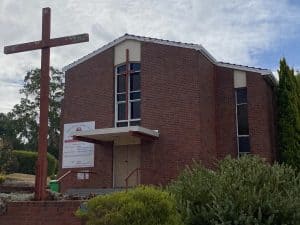 Modern brick church building with a large cross outside in Bunbury, Australia.