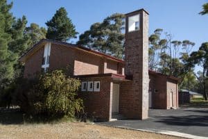 Bunbury Catholic Diocese church building with brick architecture and tall chimney.