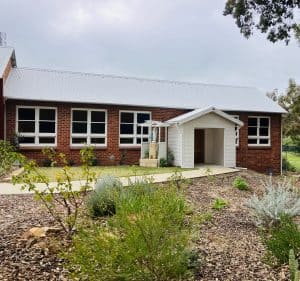 Bunbury Catholic Diocese parish building with garden and white entrance.