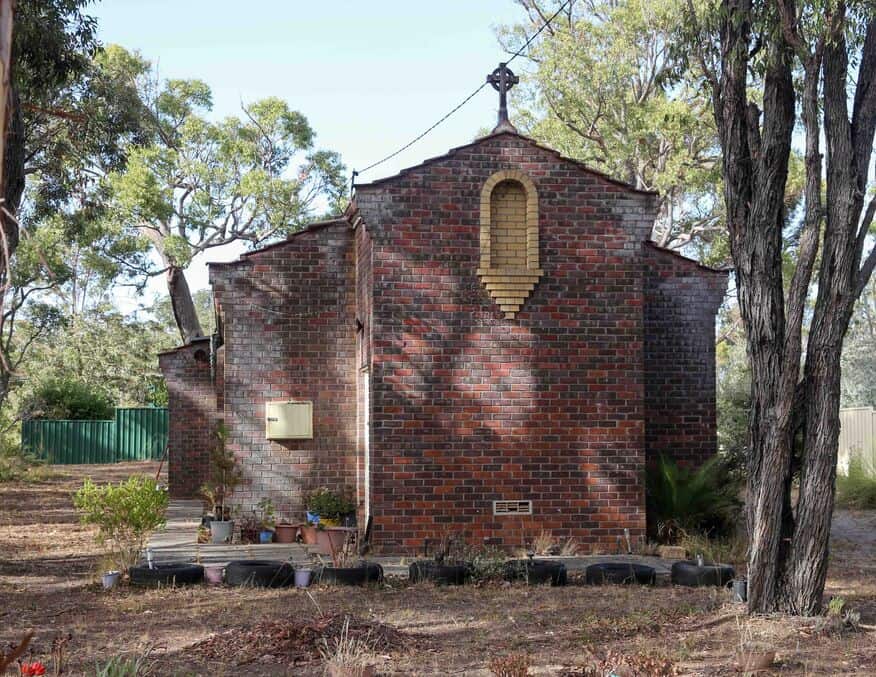 Small brick church with cross on roof in Bunbury Catholic Diocese, Australia.
