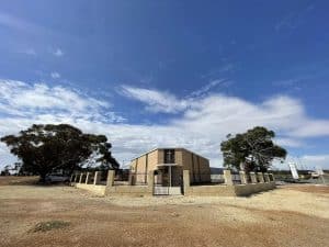 Bunbury Catholic Diocese church building with trees and blue sky.